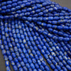 Close-up of blue cylindrical beads on a gray background