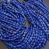 Blue cylindrical beads on a dark background