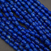 Close-up of blue marbled beads on a dark background