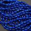 Close-up of blue marbled beads on a dark background