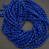 Close-up of blue marbled beads on a dark background