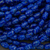 Close-up of blue marbled beads on a dark background