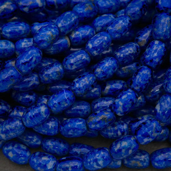 Close-up of blue marbled beads on a dark background