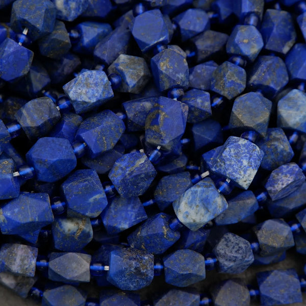 Faceted lapis lazuli nugget beads with deep blue color and pyrite flecks