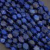 Close-up of blue faceted beads on a gray background