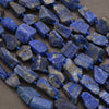 String of blue stone beads on a dark surface