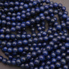Smooth round lapis lazuli beads with a glossy finish shown in multiple strands.