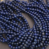 Cluster of glossy lapis lazuli beads highlighting their deep blue color and texture.