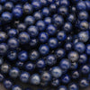 Close-up view of round lapis lazuli beads arranged in strands.