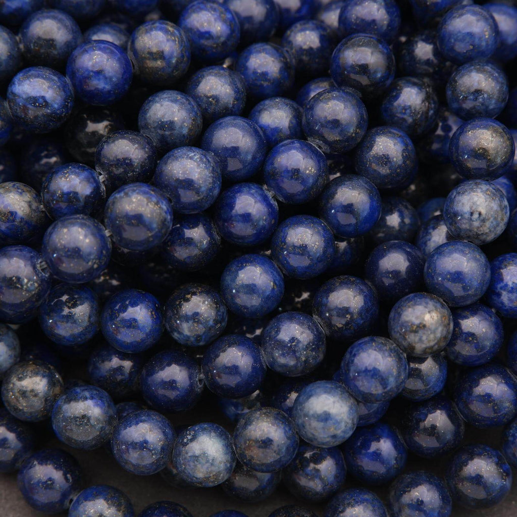 Close-up view of round lapis lazuli beads arranged in strands.
