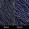 Detailed view of lapis lazuli gemstone beads arranged side by side.