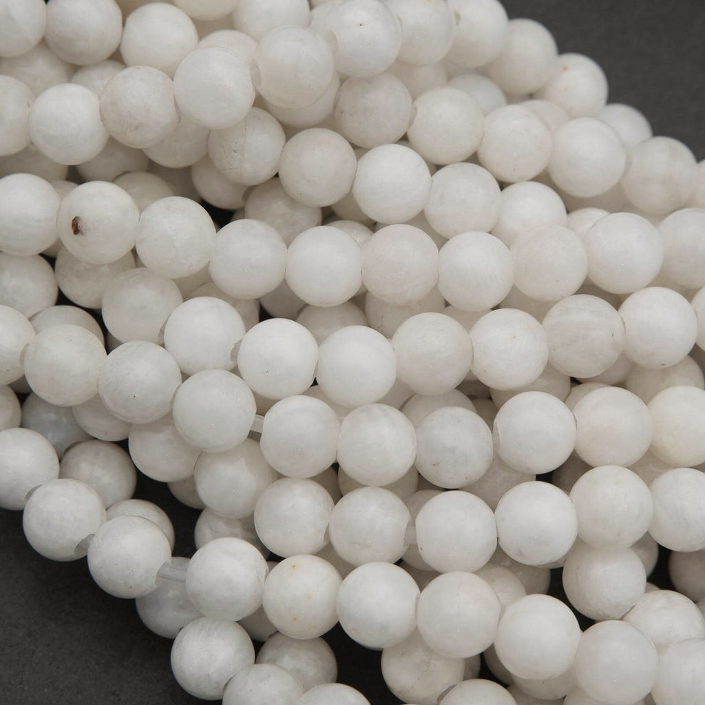 Close-up of white spherical beads on a dark background