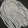 String of white ceramic beads on a dark surface