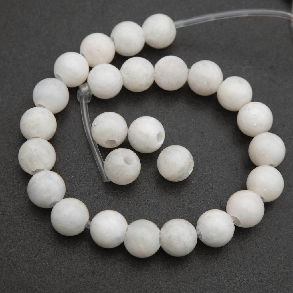 String of white beads on a dark gray background