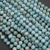 Strands of Larimar beads featuring pale blue ocean-like swirls and natural inclusions