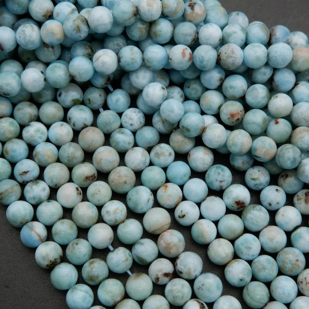 Dominican Larimar gemstone strands showing cloudy blue tones and natural stone variations