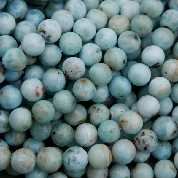 Natural Larimar gemstone beads in soft sky blue with white and earthy matrix patterns