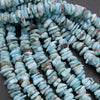 Close-up of turquoise stone beads on a dark surface