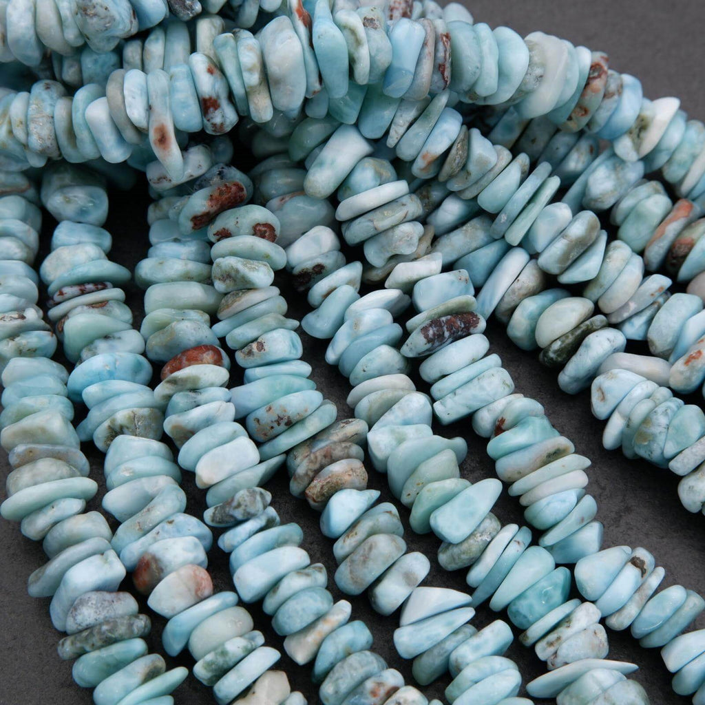 Close-up of turquoise stone beads on a dark surface