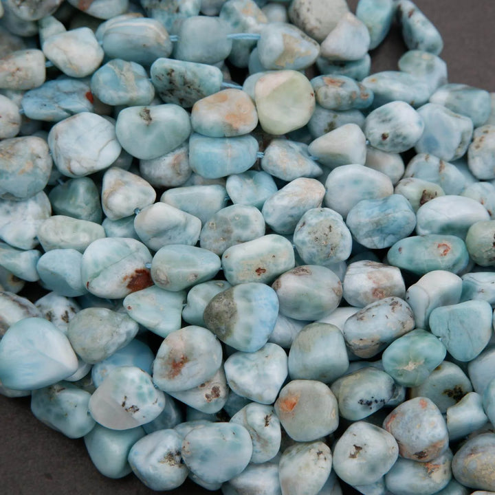 Turquoise-colored stones on a dark surface