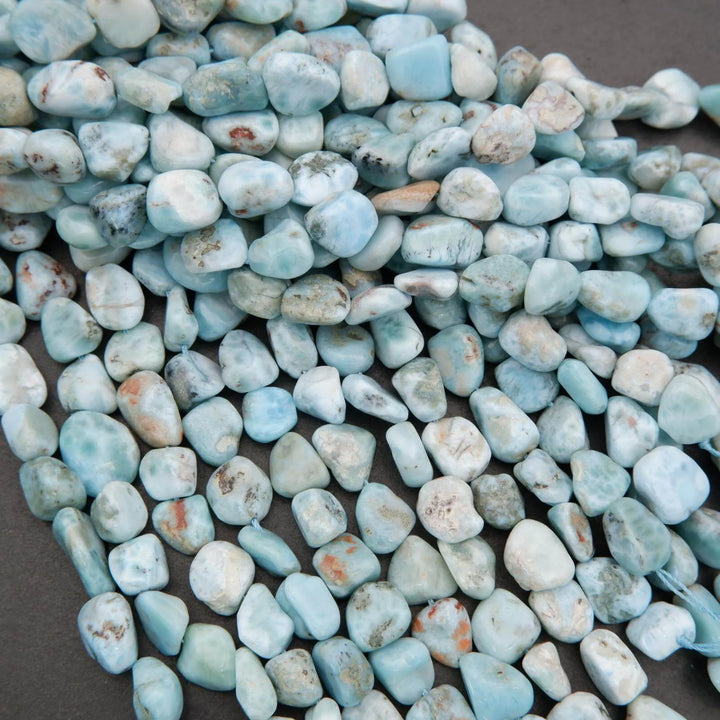 Turquoise-colored stones on a dark surface