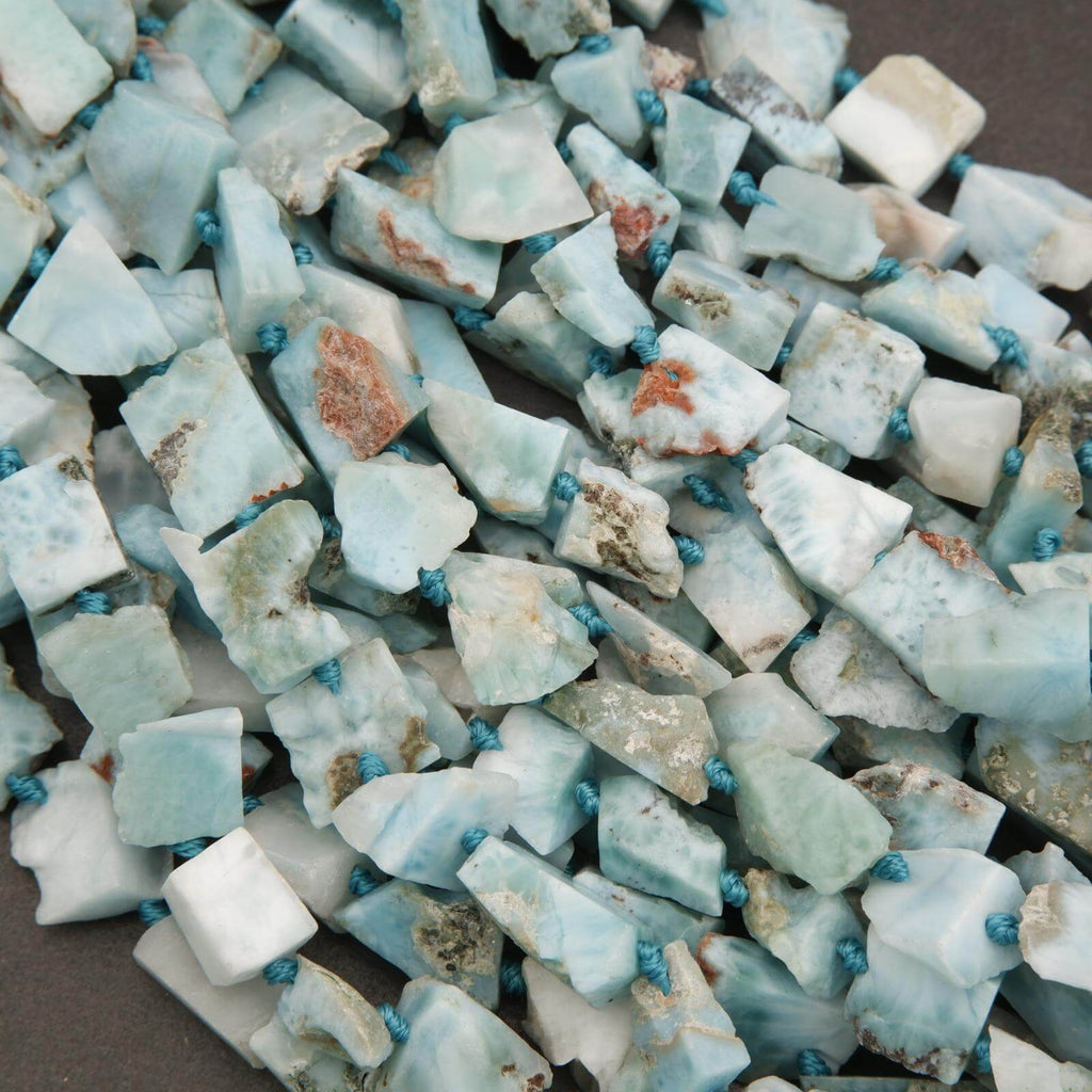 Close-up of raw larmiar stones with blue beads