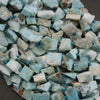 Close-up of larimar stone chips with blue beads