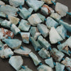 Close-up of turquoise stone beads on a dark surface