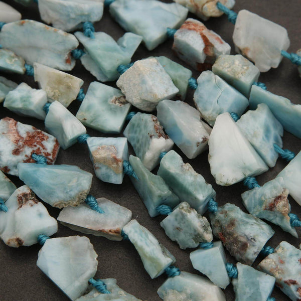 Close-up of turquoise stone beads on a dark surface