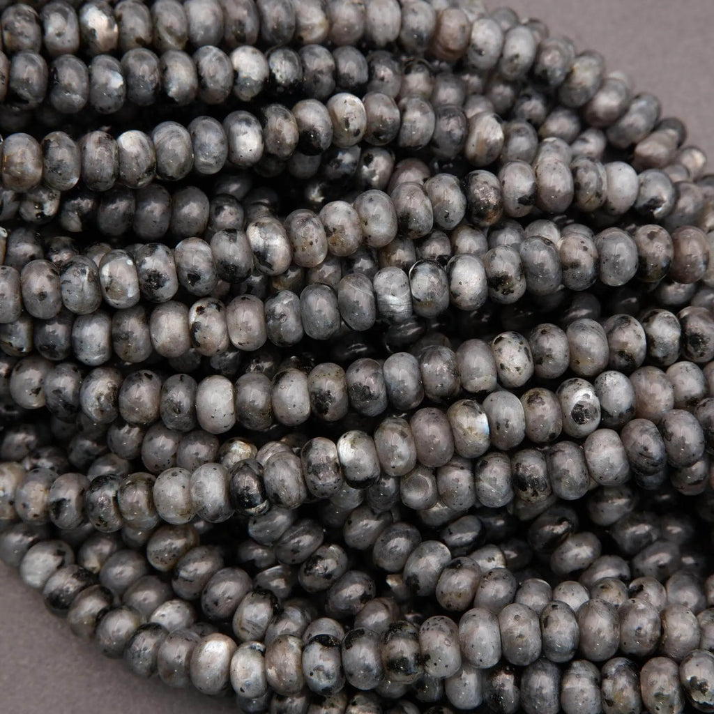 Close-up of dark gray beads on a beige background