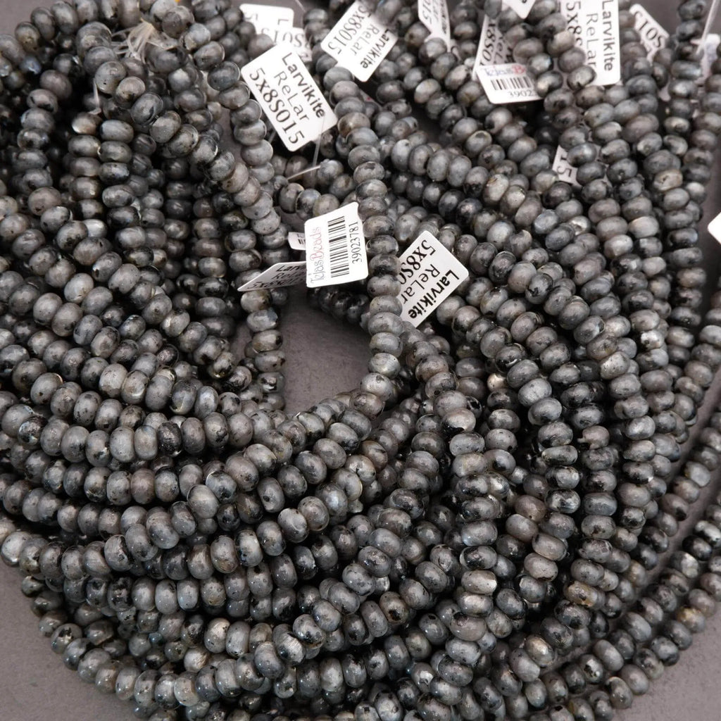 String of dark blue beads with price tags on a gray background