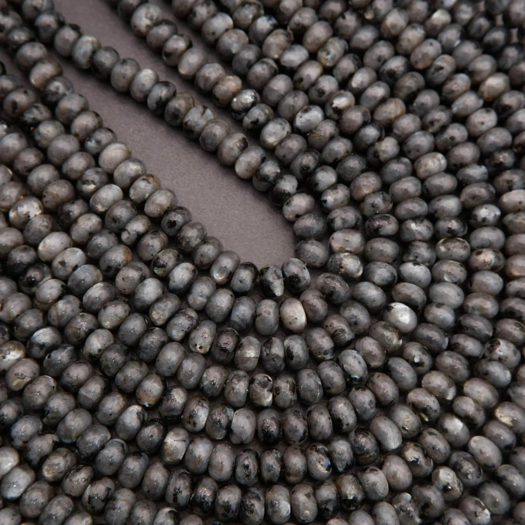 Close-up of dark gray beads on a plain background