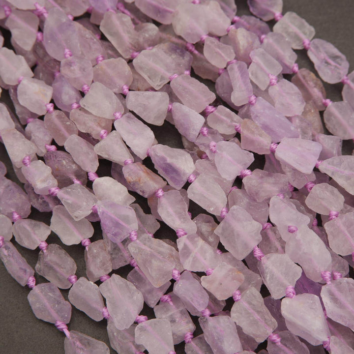 Necklace with pink stone beads on a dark background