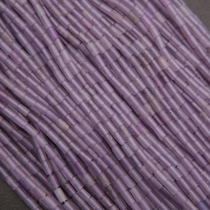 Close-up of purple cylindrical beads arranged in a pattern