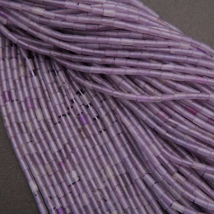 Close-up of purple cylindrical beads on a gray background