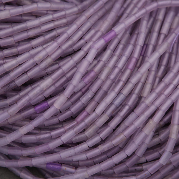 Close-up of purple and gray cylindrical beads.
