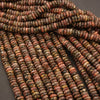 Close-up of multicolored stone beads on a dark background