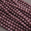 Close-up of purple beads on a gray background