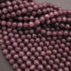 Close-up of purple beads on a gray background