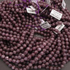 String of purple beads with labels on a gray background