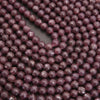 Close-up of purple beads on a dark background
