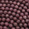 Close-up of purple beads on a dark background