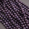Close-up of purple beads on a dark background