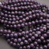 Close-up of purple beads on a dark background