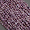 Strands of purple lepidolite beads showing subtle marbling and mineral inclusions