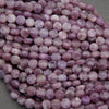 Coin shape lepidolite beads in light purple hues with natural white and silvery patterns