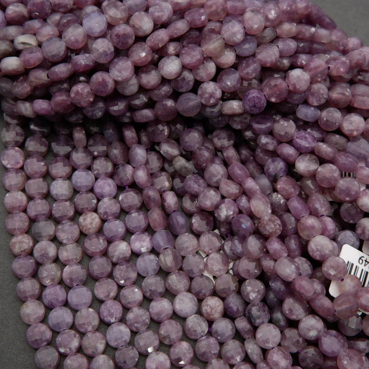 Lepidolite gemstone strands displaying lavender shades and sparkly mica flecks.