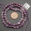 Faceted lepidolite beads in shades of lilac and plum with organic color variations
