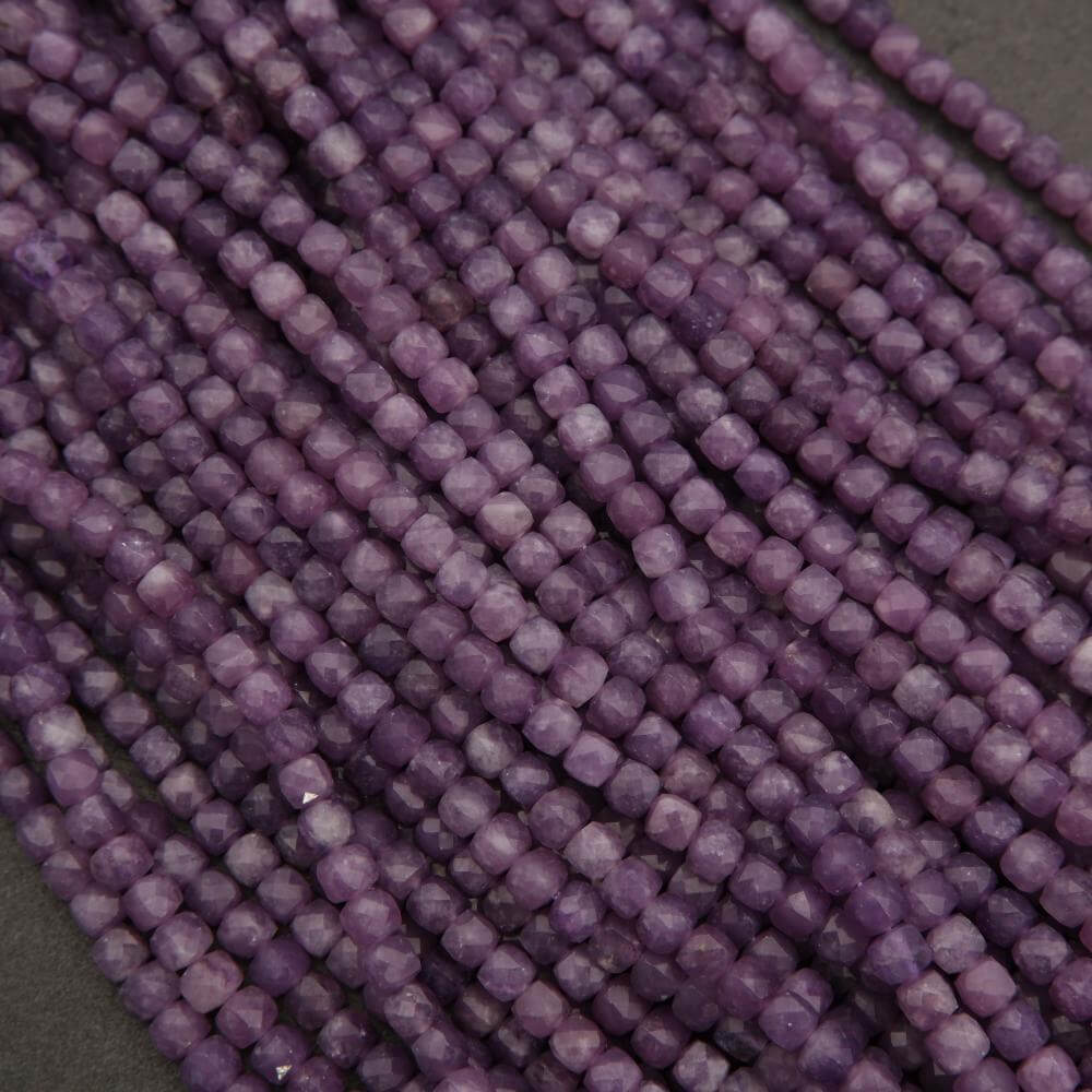 Close-up of a string of purple beads on a dark background
