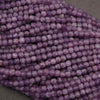 Close-up of purple beads on a dark background